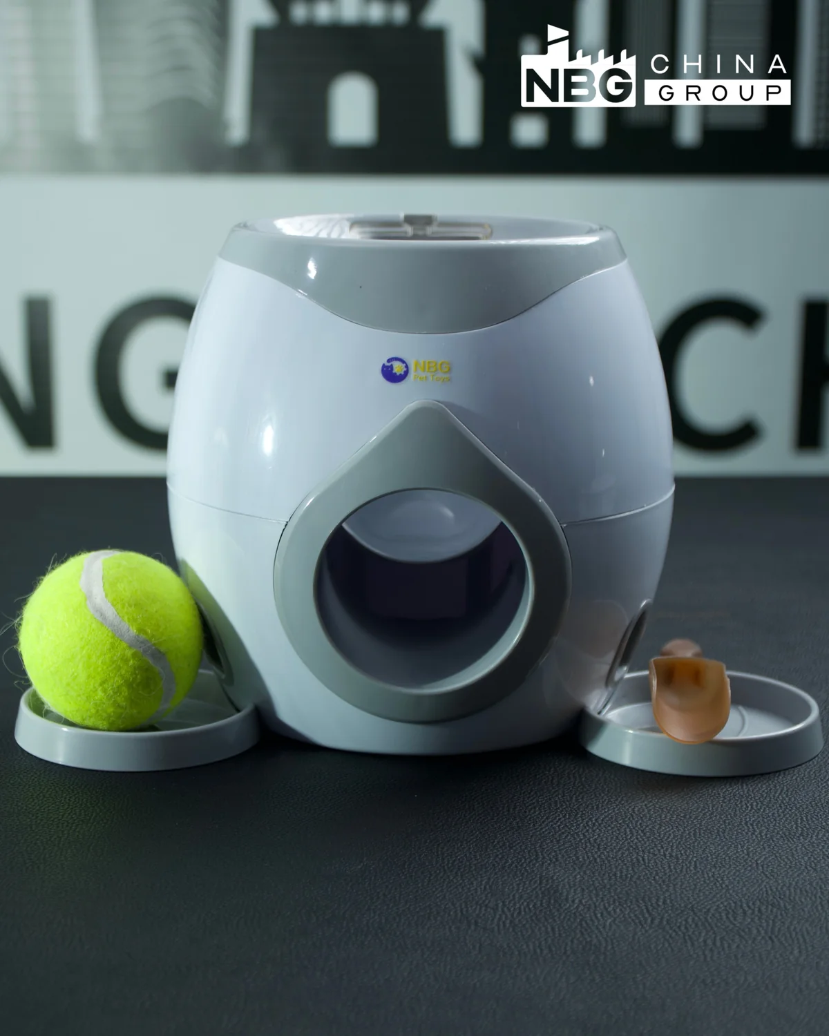 Complete grey NBG Pet interactive reward device with tennis ball