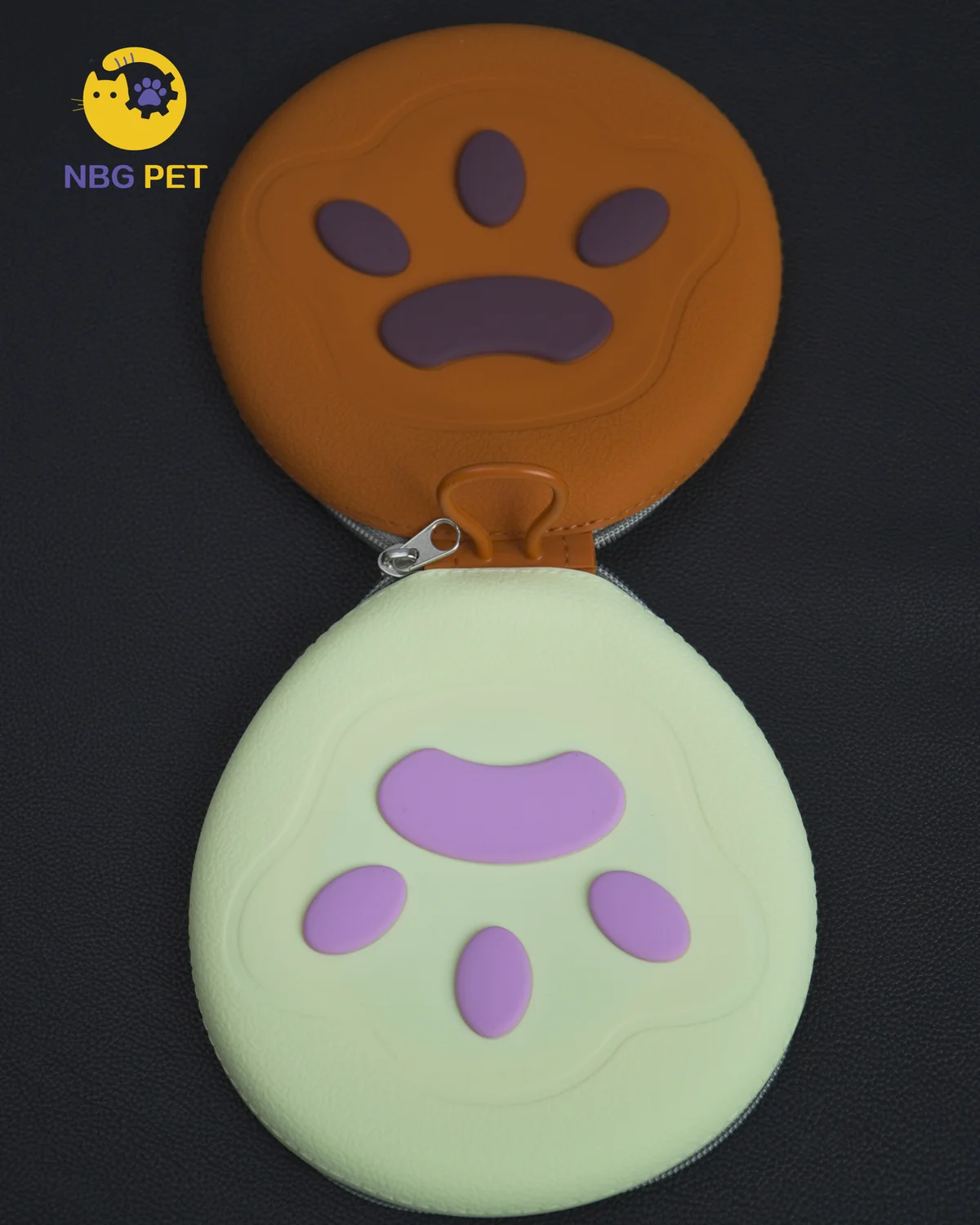 Closed orange and cream paw-shaped collapsible pet bowl